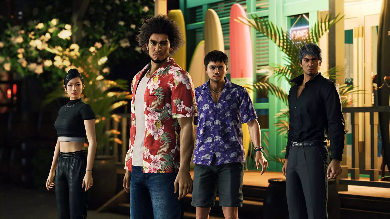Four people standing in front of a house at night, two wearing flowered shirts.